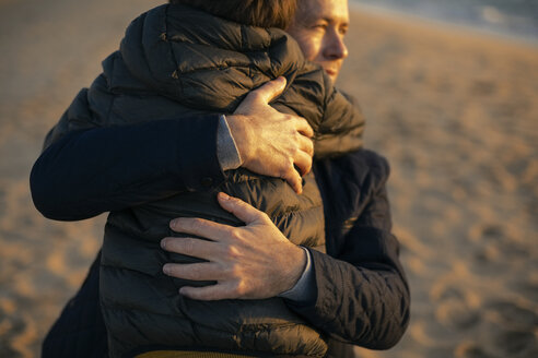 Vater, der seinen Sohn am Strand umarmt - EBSF02028