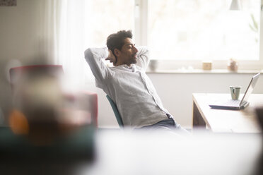 Businessman relaxing at desk - SGF02151