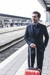 Young businessman waiting at station platform - UUF12636