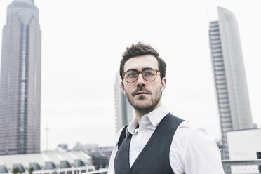 Germany, Frankfurt, portrait of young businessman in the city - UUF12649