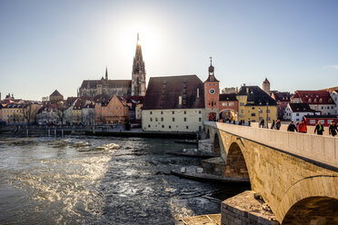 Germany, Regensburg, view to cathedral at the old town with Steinerne Bruecke over Danube river - PUF01267