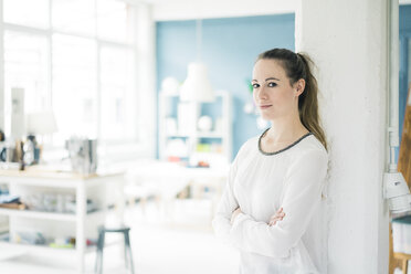 Portrait of smiling young woman in a loft - MOEF00719