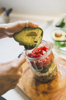 Woman preparing salad to go on chopping board - ASCF00800