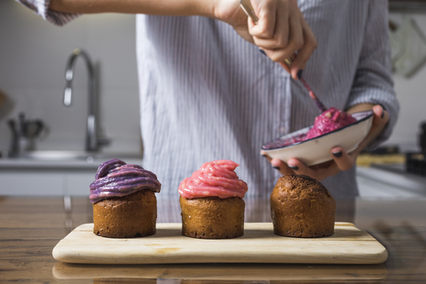 Woman preparing muffins at home stock photo