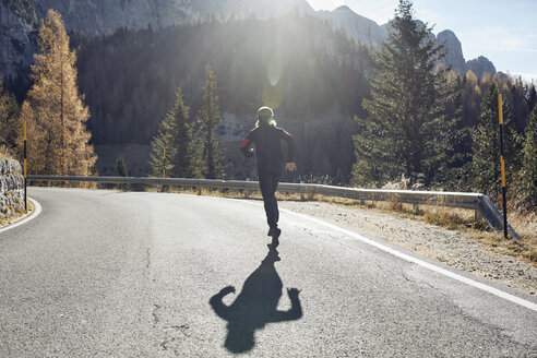 Man running on mountain road - PNEF00436