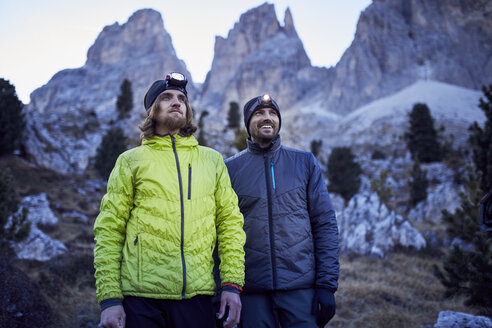 Two confident men wearing headlamps in the mountains - PNEF00456