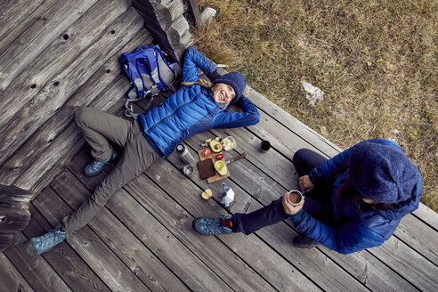 Overhead view of couple hikers having a break at mountain hut - PNEF00473