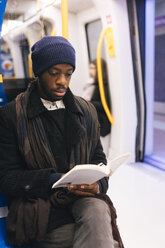 African american man reading a book - MAUF01292