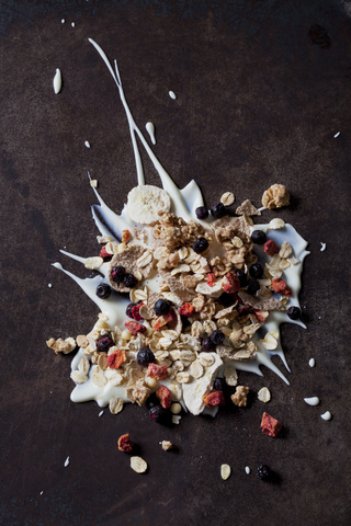 Fruit muesli with dried fruits on yoghurt splash stock photo