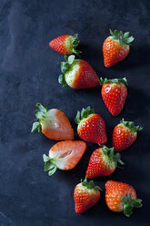 Sliced and whole strawberries on dark ground - CSF28887
