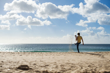 Spain, Lanzarote, father with baby girl on the beach - DIGF03235