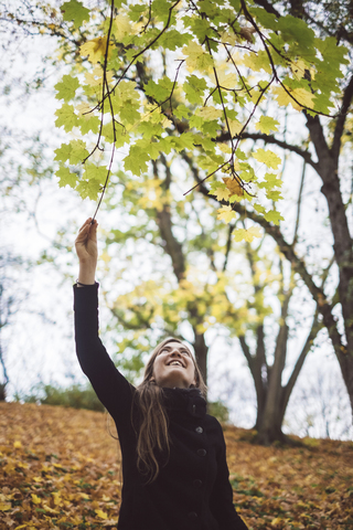 Happy young woman in autumnal forest stock photo
