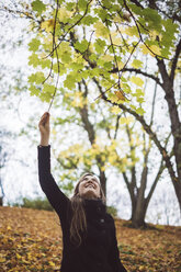 Happy young woman in autumnal forest - JSCF00039