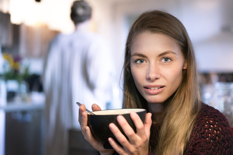 Portrait of blond woman holding bowl stock photo