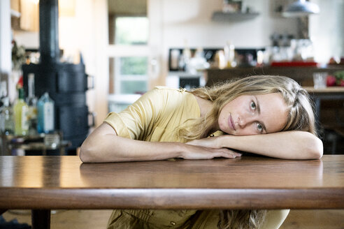 Porträt einer blonden Frau auf einem Tisch liegend - PESF00984