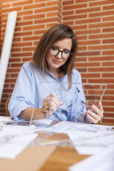 Young woman working in architecture office - VABF01486