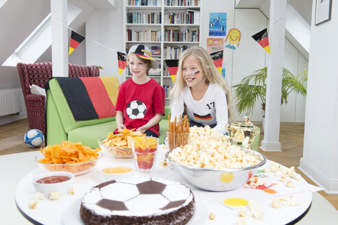 Bruder und Schwester schauen Fußball-Weltmeisterschaft mit Süßigkeiten und Snacks - NEKF00022