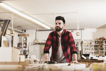 Portrait of confident man in workshop - UUF12717