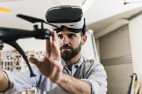 Man wearing VR glasses holding drone stock photo