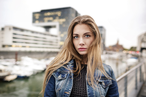Portrait of attractive young woman at city harbor stock photo