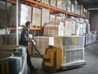 Man operating pallet jack in storehouse - CVF00135