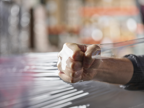 Fist inside plastic foil testing stability stock photo