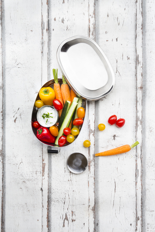 Lunch box with carrot, paprika, cucumber, tomato and chive dip stock photo