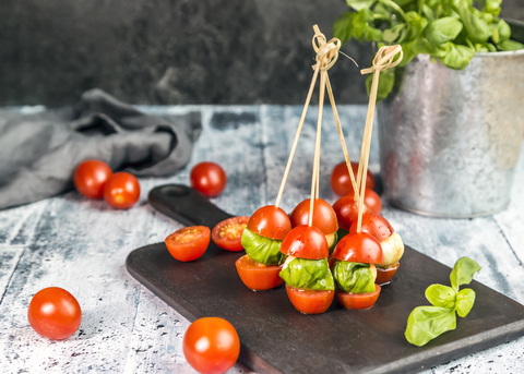 Tomato mozzarella sticks, basil stock photo