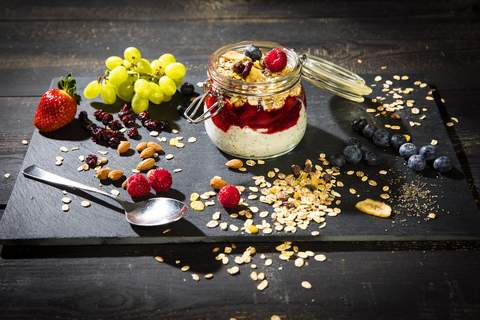 Muesli with Red Fruit Jelly, chia, curd, raspberry, almond, cranberry, blue berry, dried banana, grape stock photo