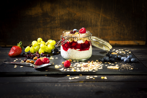 Muesli with Red Fruit Jelly, chia, curd, raspberry, almond, cranberry, blue berry, dried banana, grape stock photo