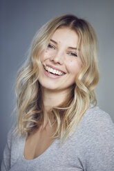 Portrait of laughing blond woman with moles - PNEF00521