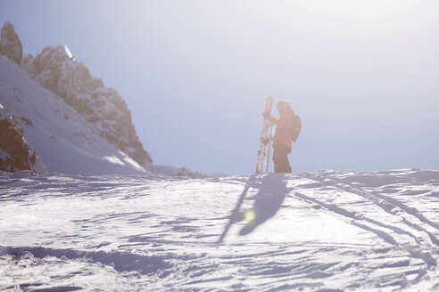 Austria, Tyrol, Mutters, freeride skier ascending mountain - CVF00140