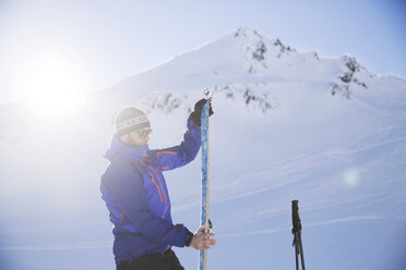 Austria, Tyrol, Kuehtai, freeride skier preparing ski for a ski tour - CVF00146