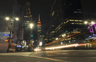 USA, New York City, Eighth Avenue and Empire State Building at night - SEEF00011