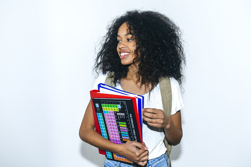 Porträt einer jungen Studentin mit Buch und Mappen - KIJF01903