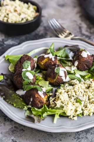 Plate of Falafel, salad, yogurt sauce with mint and Tabbouleh stock photo