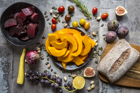 Pumpkin panzanella, bread salad of pumpkins, onions, tomatoes, grapes and figs stock photo