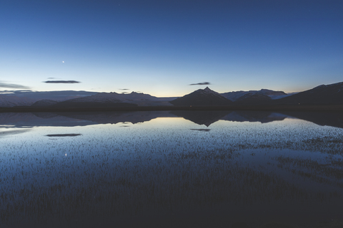 Iceland, Hofn, View of lake and mountains after sunset stock photo