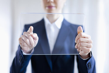 Close-up Of Businesswoman Touching On Blank Futuristic Digital Tablet - FSIF00021