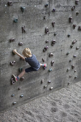 Full length rear view of boy climbing artificial rock - FSIF00025