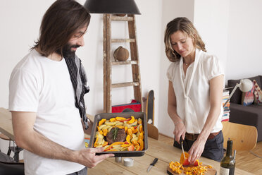 Couple preparing pumpkin dish at home - FSIF00032