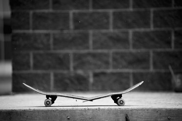 Broken skateboard on sidewalk - FSIF00118