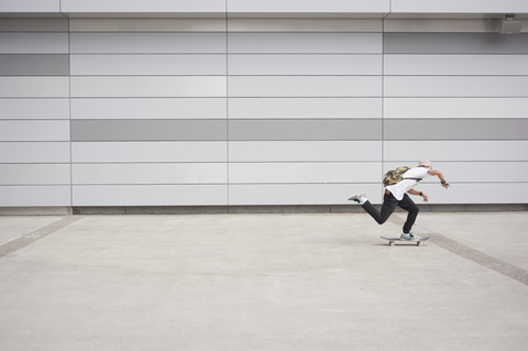 Full length of man skateboarding outdoors stock photo