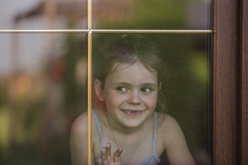 Close-up of girl looking out through window - FSIF00232