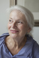 Close-up of smiling senior woman looking away at home - FSIF00265