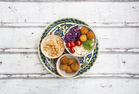 Sweet potato balls, Couscous, Hummus and vegetables in bowls - LVF06687
