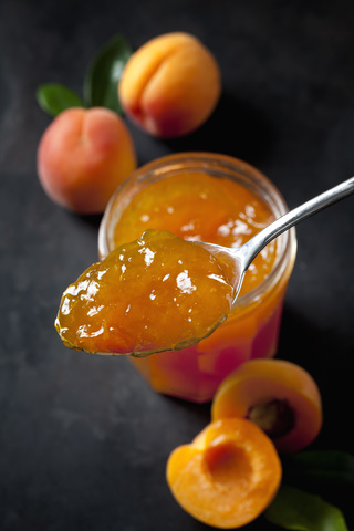 Spoon of apricots jam, close-up stock photo