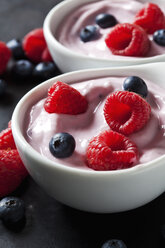 Two bowls of fruit yoghurt with blueberries and raspberries - CSF28921