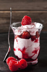 Glass of trifle with whipped cream, strawberries and strawberry sauce - CSF28922