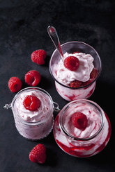 Trifle aus Schlagsahne mit Erdbeeren und Erdbeersauce in verschiedenen Gläsern - CSF28925